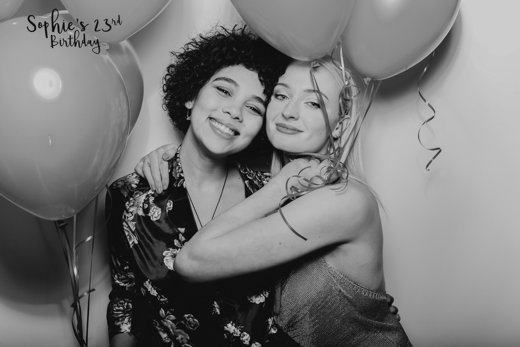Two birthday guests posing with balloons