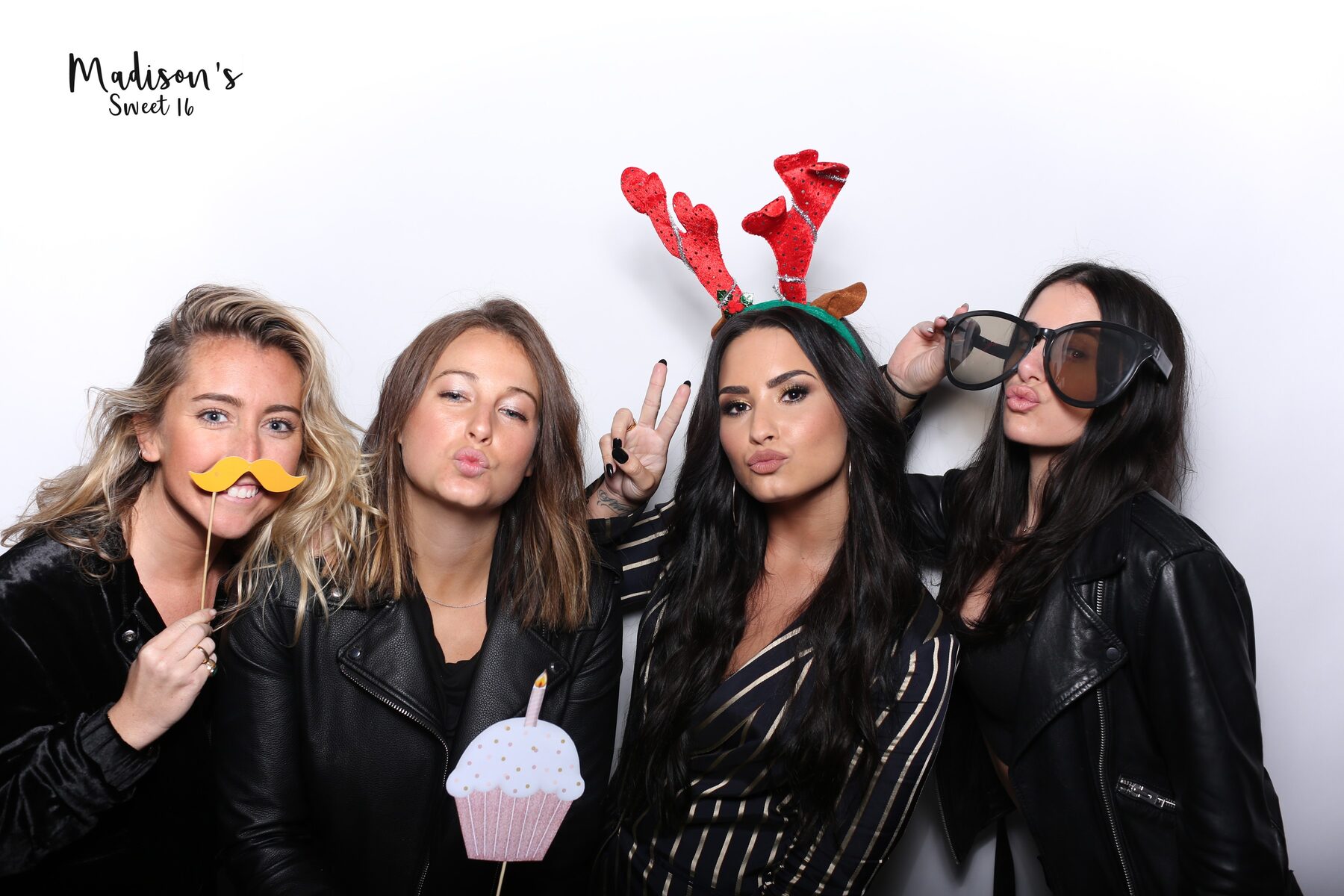 Friends posing at a photo booth event